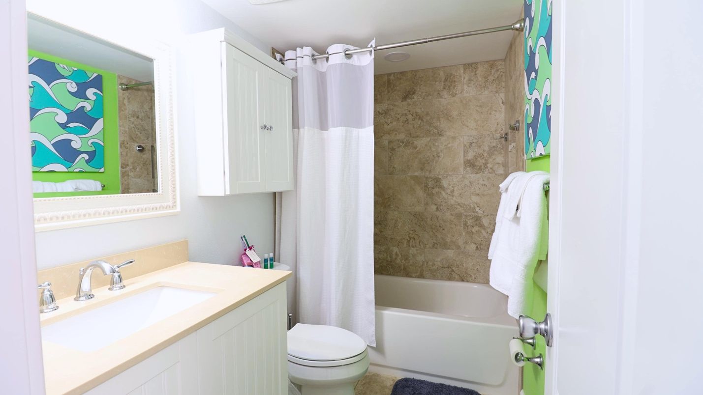 A bathroom with a white shower curtain Description automatically generated