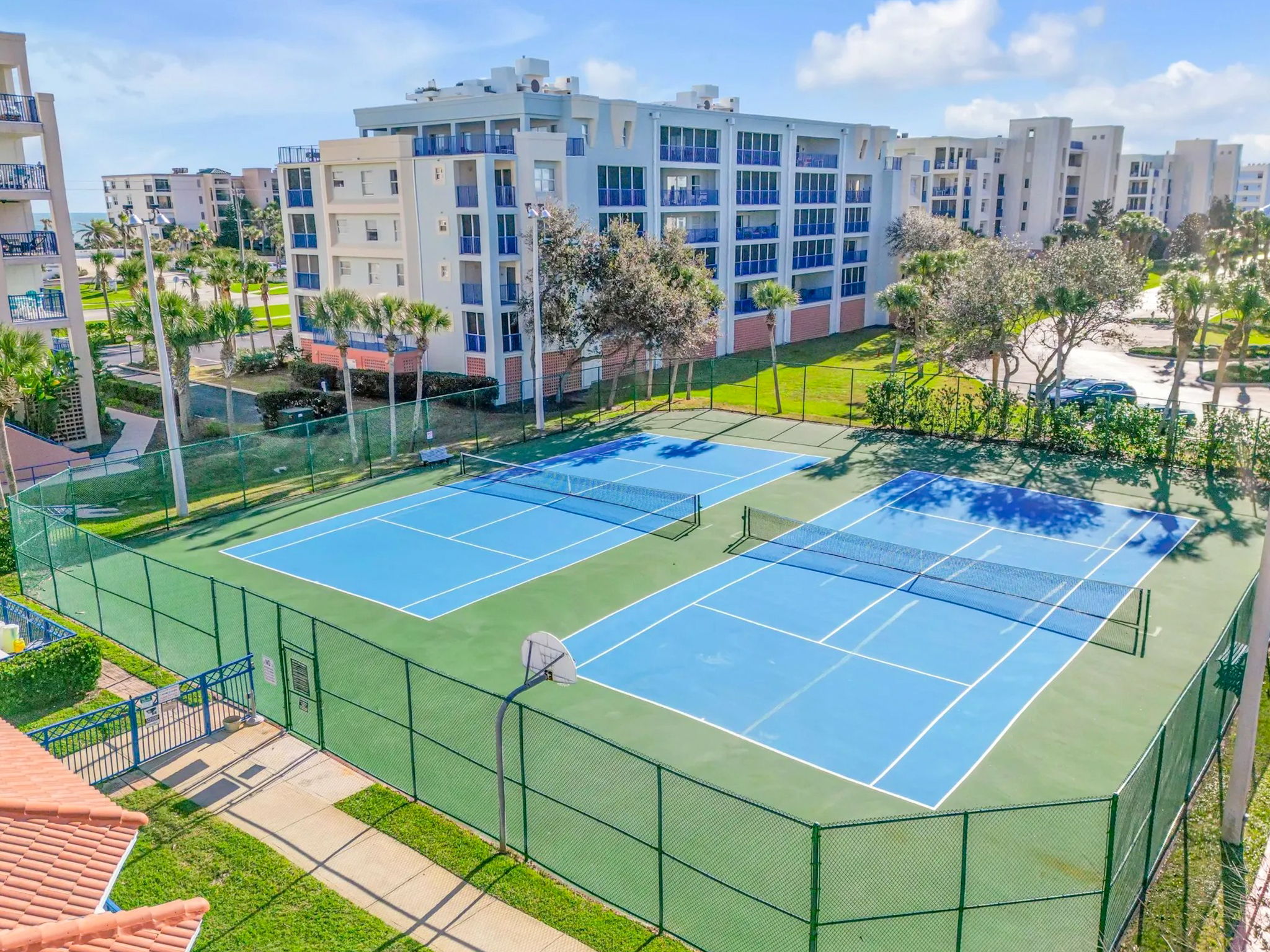 Tennis courts surrounded by condo buildings at the Oceanwalk complex in New Smyrna Beach