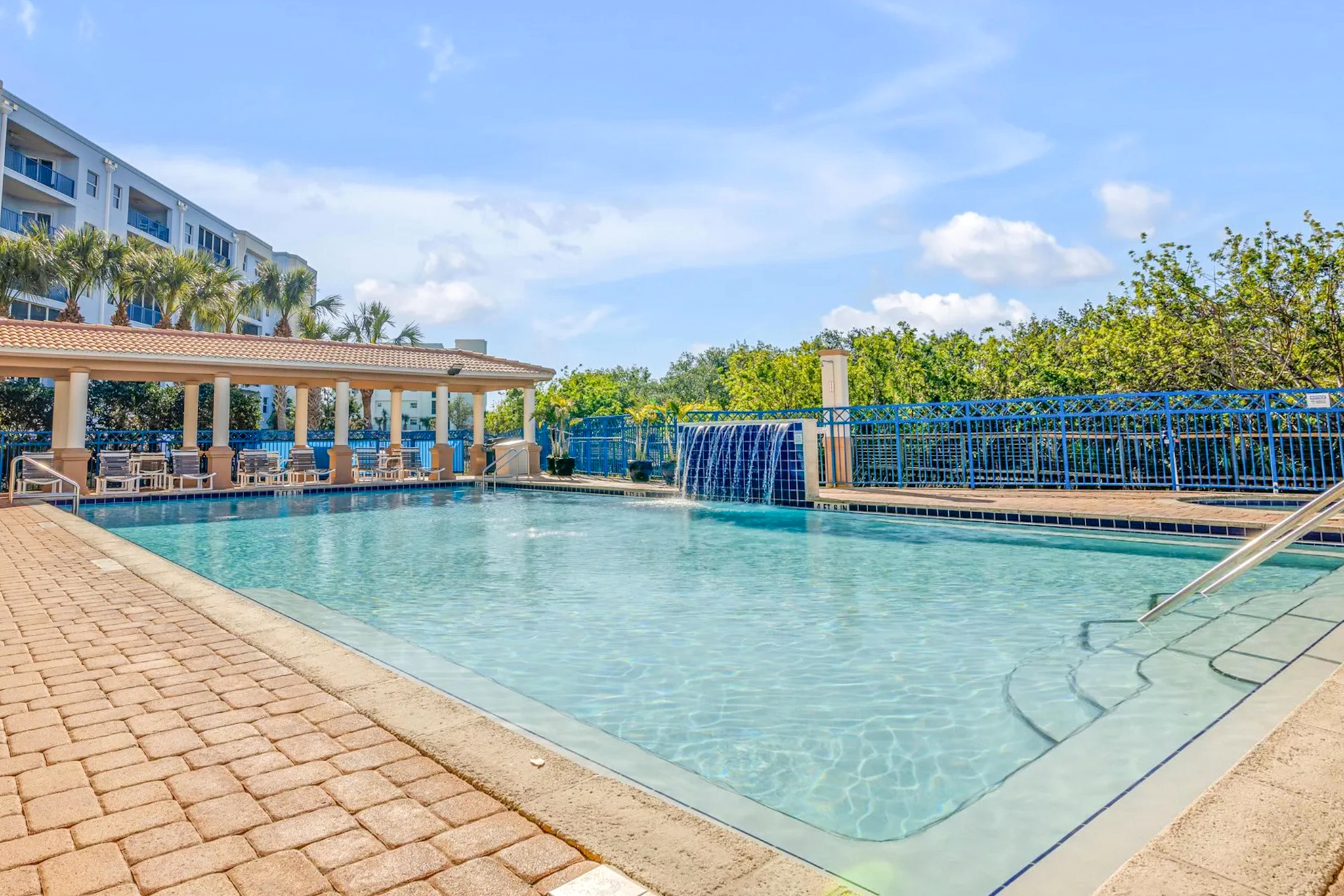 Resort-style swimming pool with waterfall feature at the Oceanwalk condo complex in New Smyrna Beach